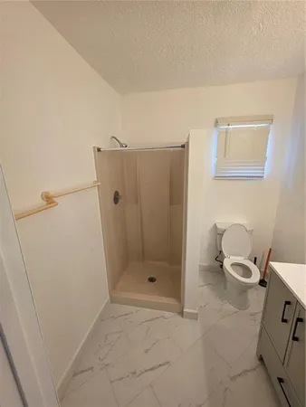 a bathroom with a shower and toilet