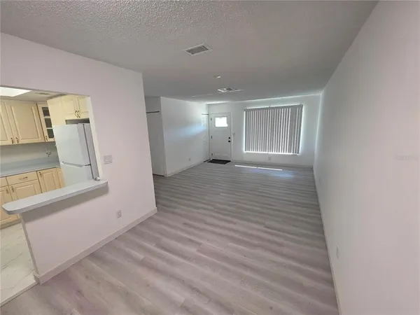 a view of a room with wooden floor and staircase