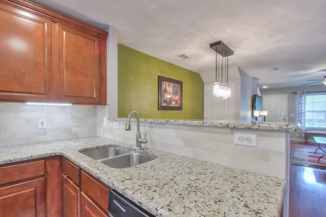 a kitchen with a sink a counter space and cabinets
