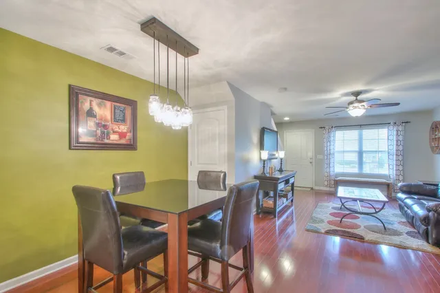 a view of a dining room with furniture window and wooden floor