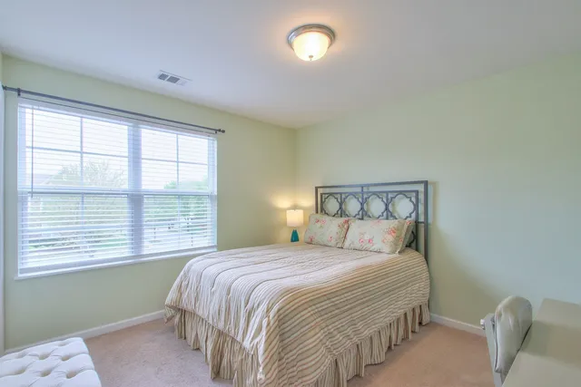 a bedroom with a bed and a chair