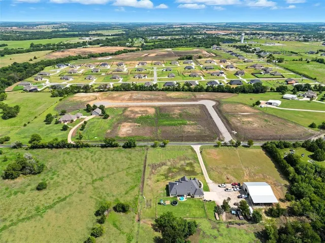 an aerial view of a residential houses with outdoor space