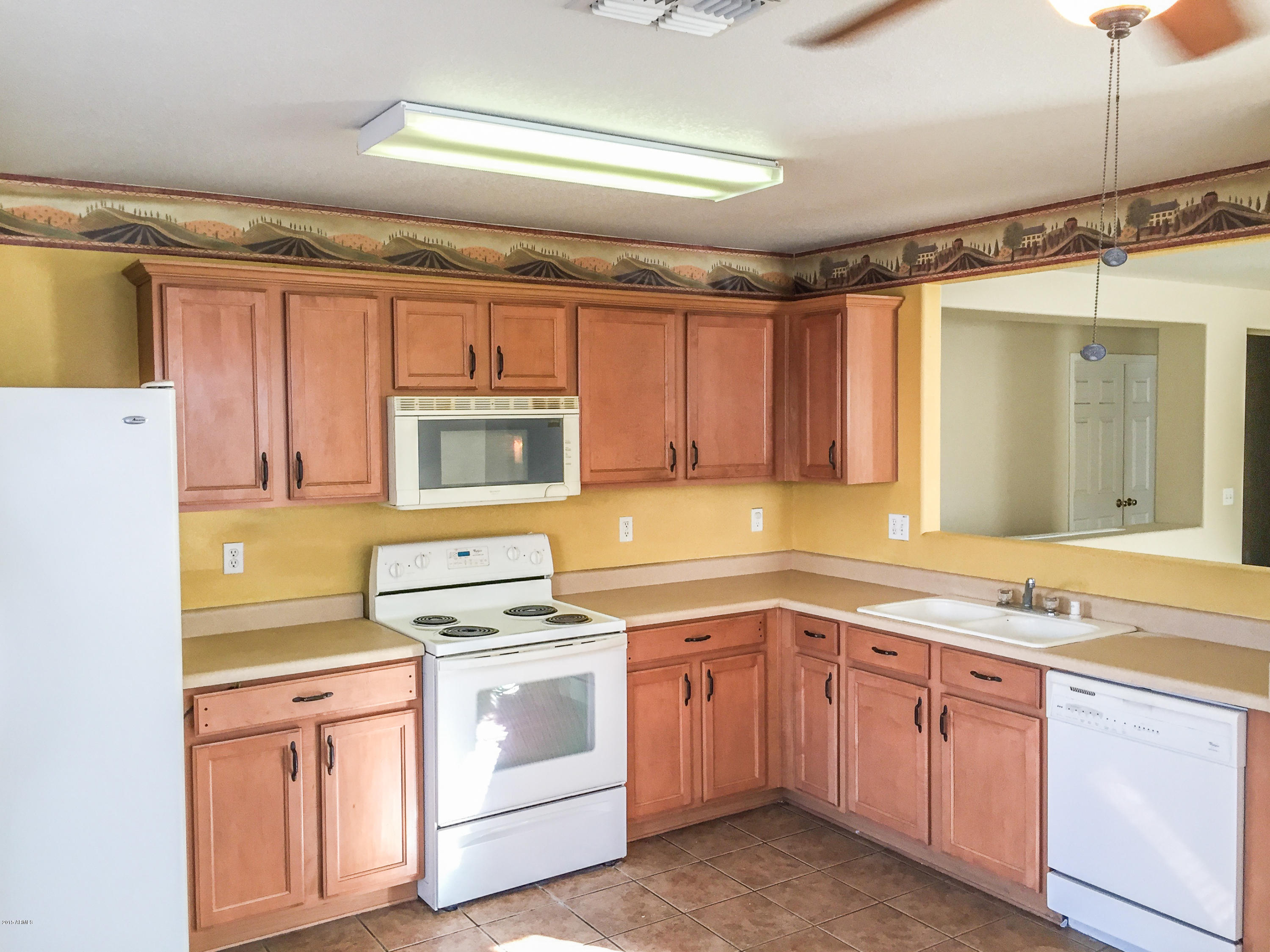 3338 South Conestoga Road Apache Junction, AZ 85119 - Photo 3 of 10 a kitchen with cabinets appliances a sink and a counter top space