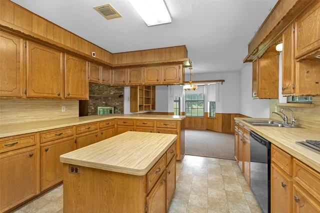 a kitchen with stainless steel appliances granite countertop a sink and cabinets