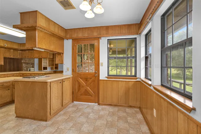 a view of an entryway with a tub and windows