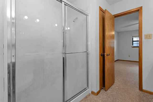 a view of bathroom with a shower and a sink