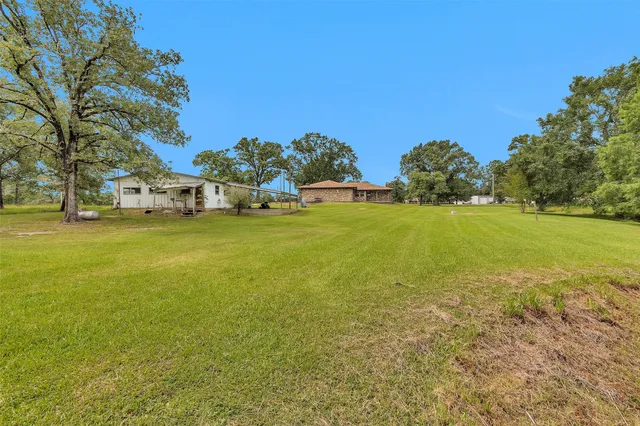 a view of a large body of water with lawn chairs under an umbrella