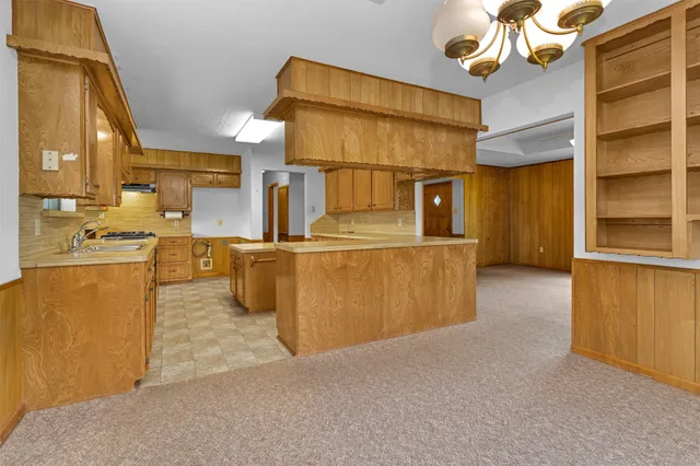 a kitchen with stainless steel appliances granite countertop a sink and a refrigerator
