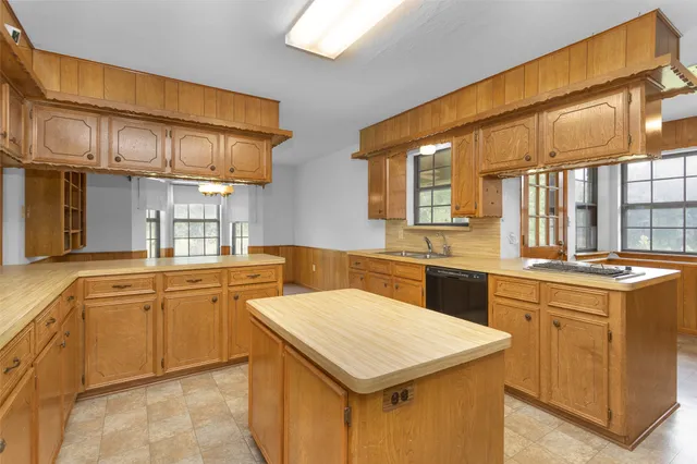 a kitchen that has a sink and a stove in it