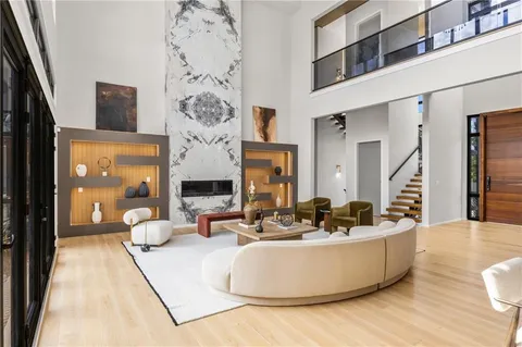 a living room with furniture large window and a table