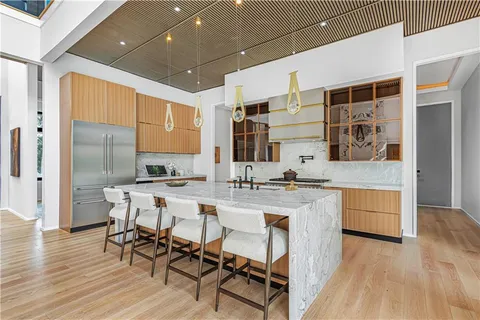 a kitchen with granite countertop a sink and a refrigerator