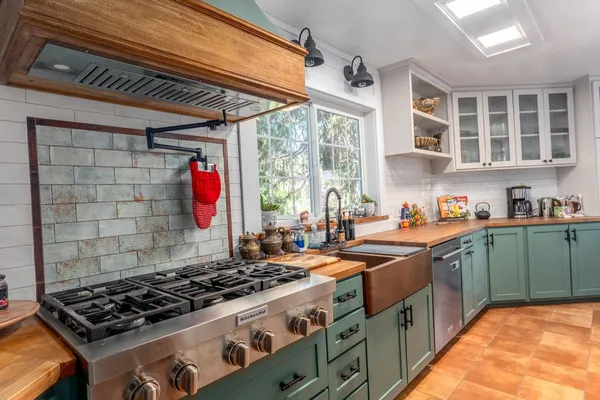 a kitchen with a stove a sink and a refrigerator