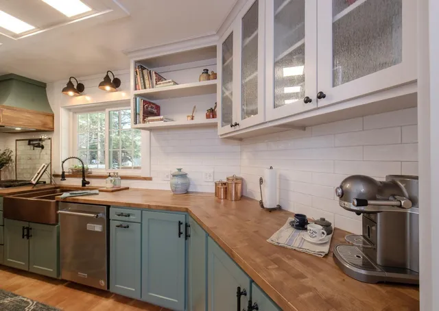 a kitchen with stainless steel appliances granite countertop a sink stove and cabinets