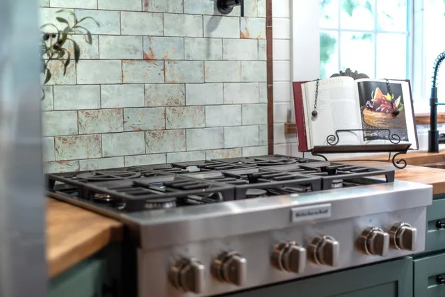 a stove top oven sitting inside of a kitchen