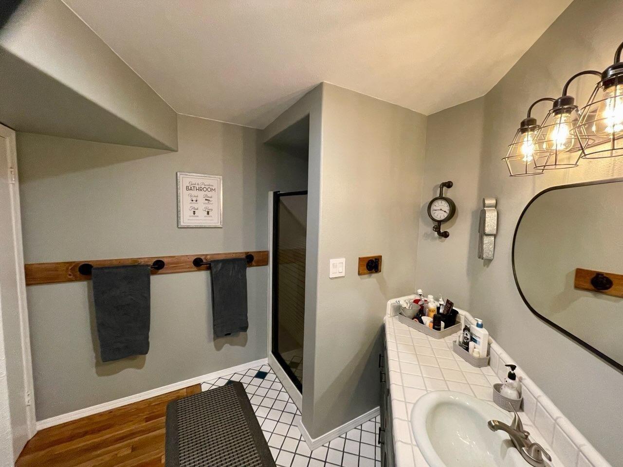 33952 Tocaloma Road Auberry, CA 93602 - Photo 16 of 39 a bathroom with a sink and mirror
