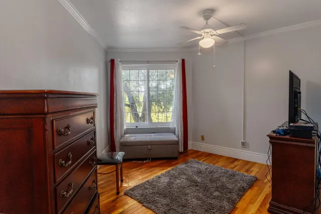 a bedroom with a bed and a television