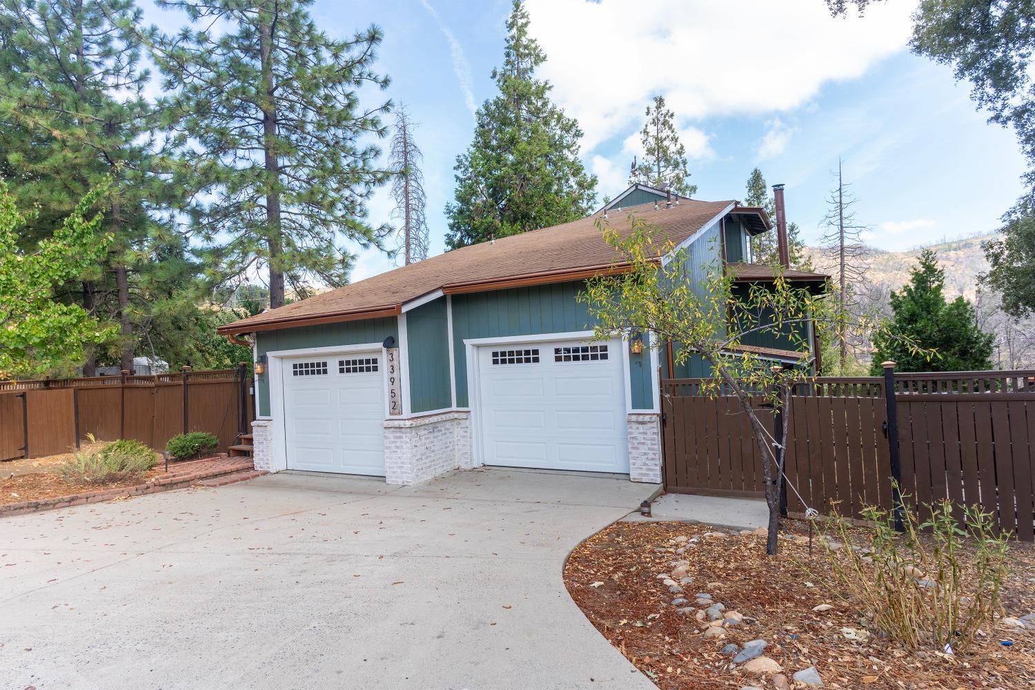 33952 Tocaloma Road Auberry, CA 93602 - Photo 2 of 39 a view of a house with a wooden fence