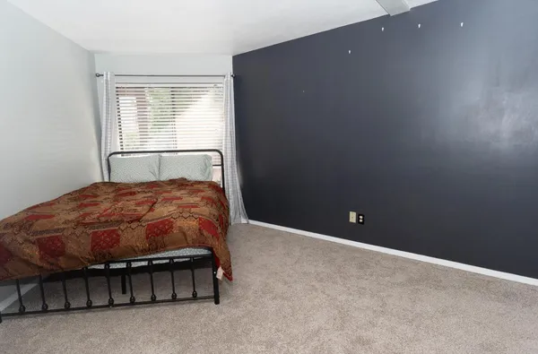 a bed sitting in a room next to a window