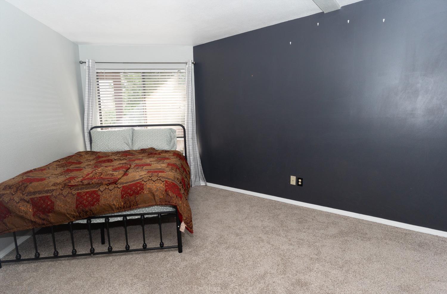 33952 Tocaloma Road Auberry, CA 93602 - Photo 21 of 39 a bed sitting in a room next to a window