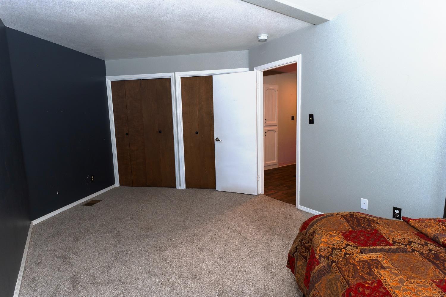 33952 Tocaloma Road Auberry, CA 93602 - Photo 22 of 39 a bedroom with a bed and a closet