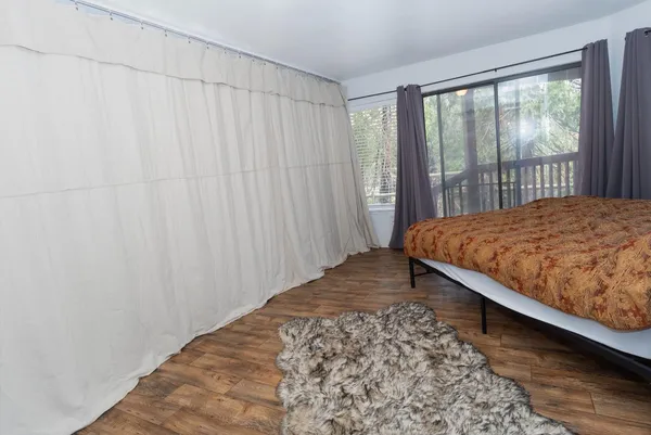 a bedroom with a bed and a window