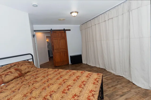 a bedroom with a bed and a mirror