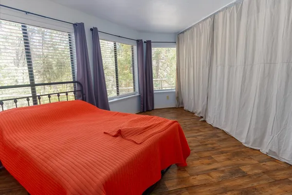 a bed sitting in a bedroom next to a window