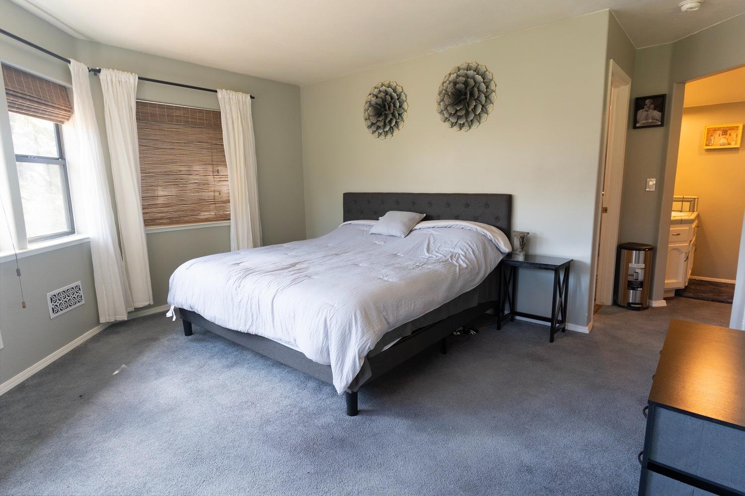 33952 Tocaloma Road Auberry, CA 93602 - Photo 28 of 39 a bedroom with a bed and a tv on the dresser