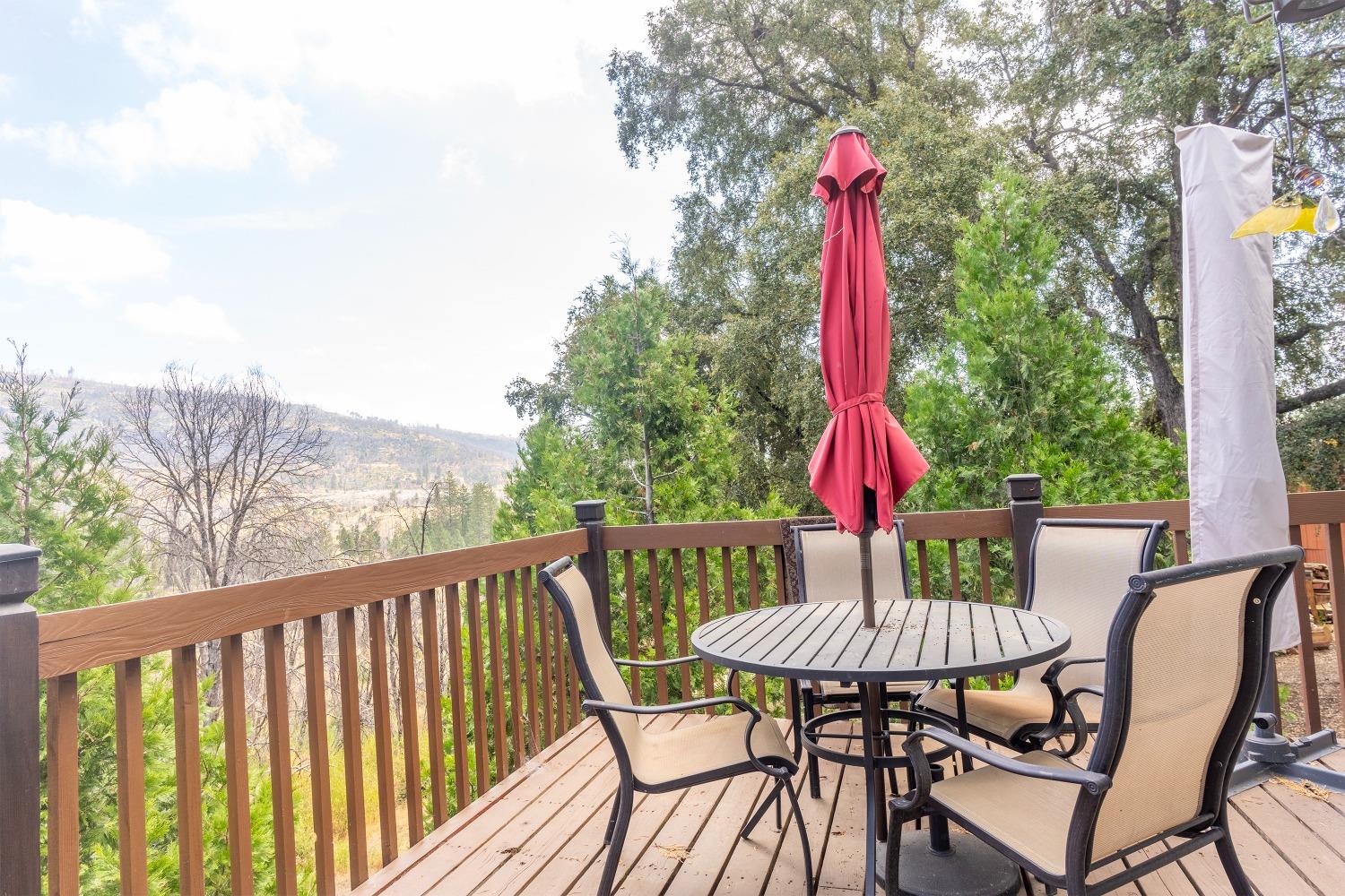 33952 Tocaloma Road Auberry, CA 93602 - Photo 31 of 39 a view of a dining table and chairs on the roof deck