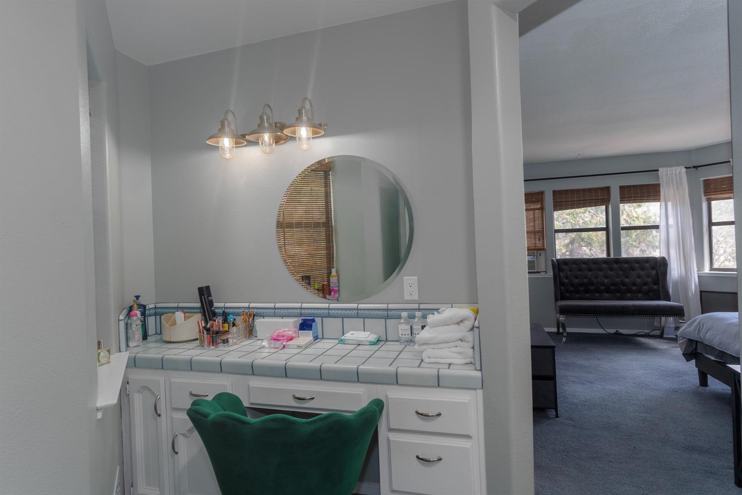 33952 Tocaloma Road Auberry, CA 93602 - Photo 37 of 39 a bathroom with a sink mirror and toilet
