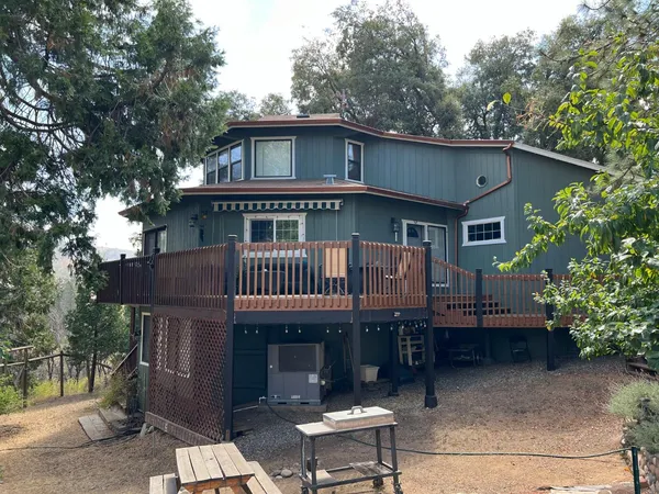 a view of a house with a yard and roof deck