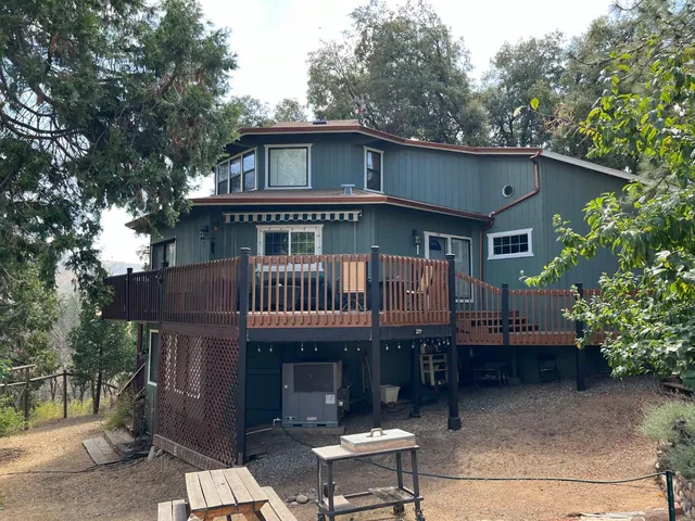 a view of a house with a yard and roof deck
