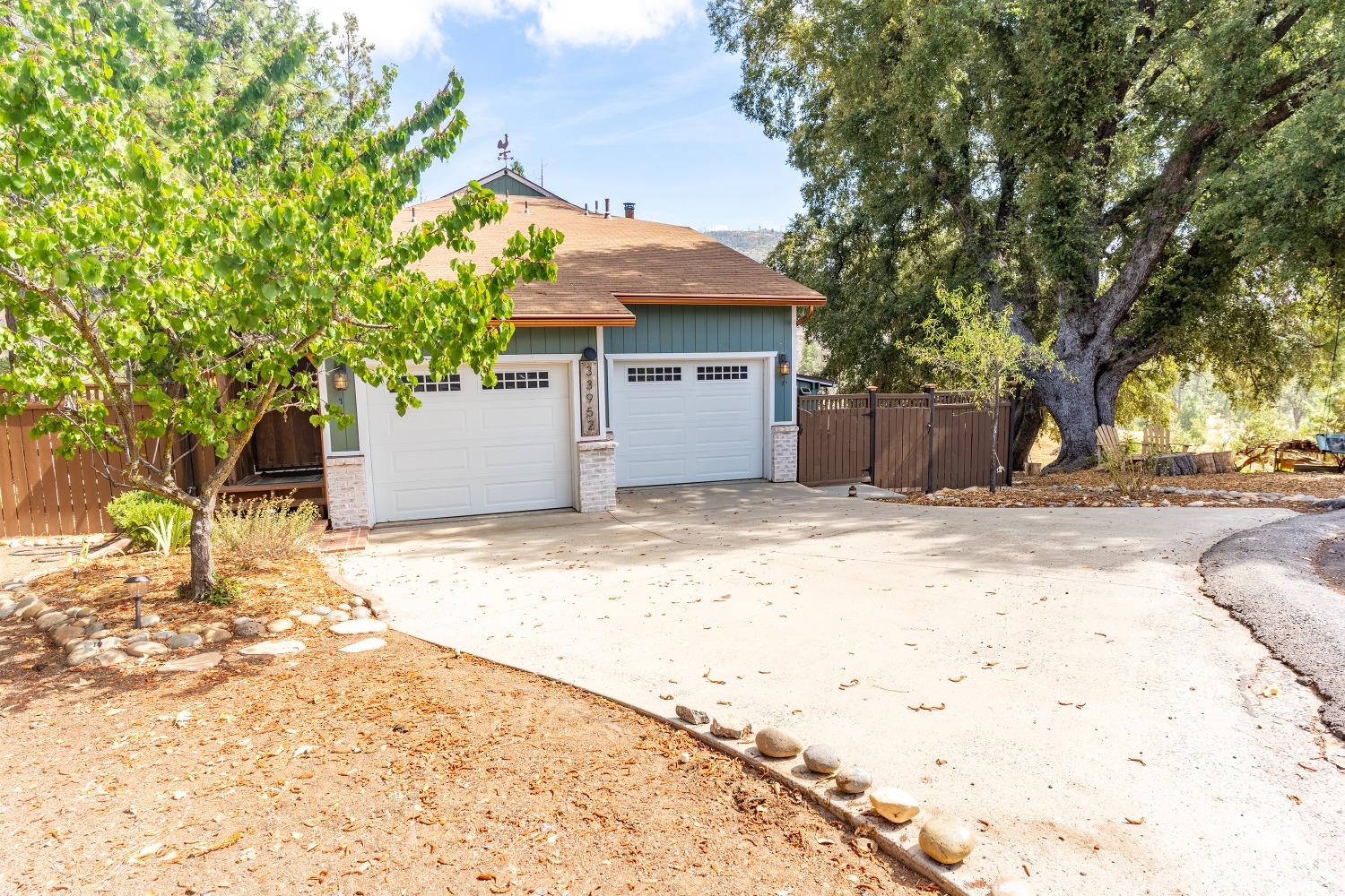 33952 Tocaloma Road Auberry, CA 93602 - Photo 6 of 39 a front view of a house with a yard and garage