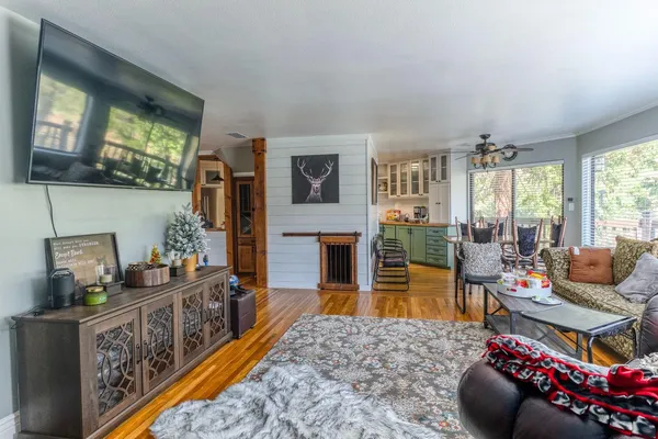 a living room with furniture fireplace and flat screen tv