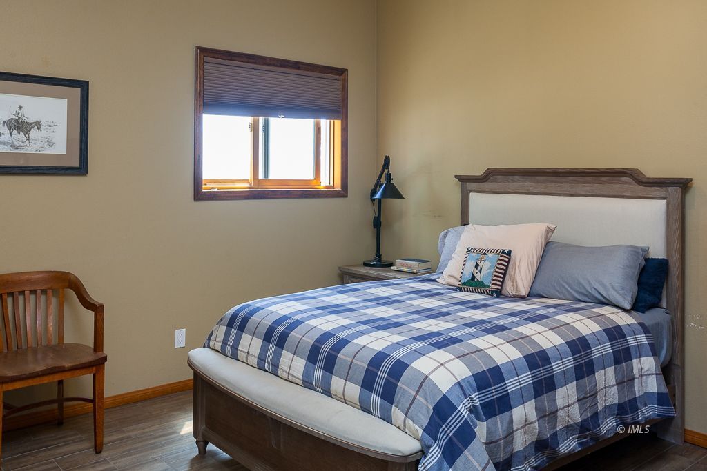 400 Dominy Road Lone Pine, CA 93545 - Photo 15 of 33 a bedroom with a bed and wooden floor