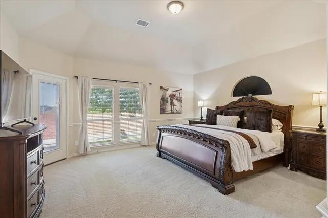 a spacious bedroom with a bed and a window