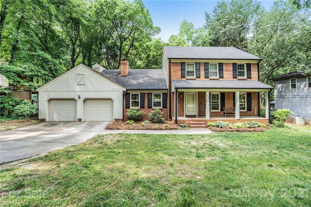 613 Neill Ridge Road Matthews, NC 28105 - Photo 1 of 25 a front view of a house with a yard and porch