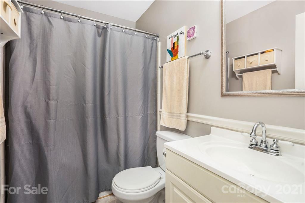 613 Neill Ridge Road Matthews, NC 28105 - Photo 15 of 25 a bathroom with a sink and a mirror