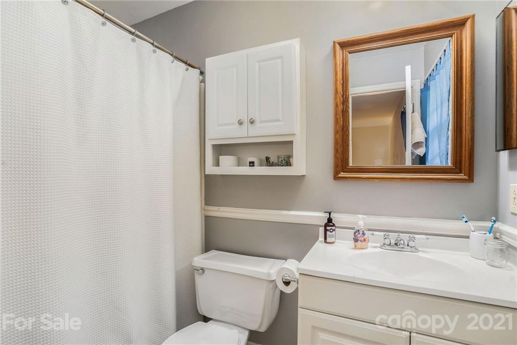 613 Neill Ridge Road Matthews, NC 28105 - Photo 17 of 25 a bathroom with a sink vanity mirror and toilet