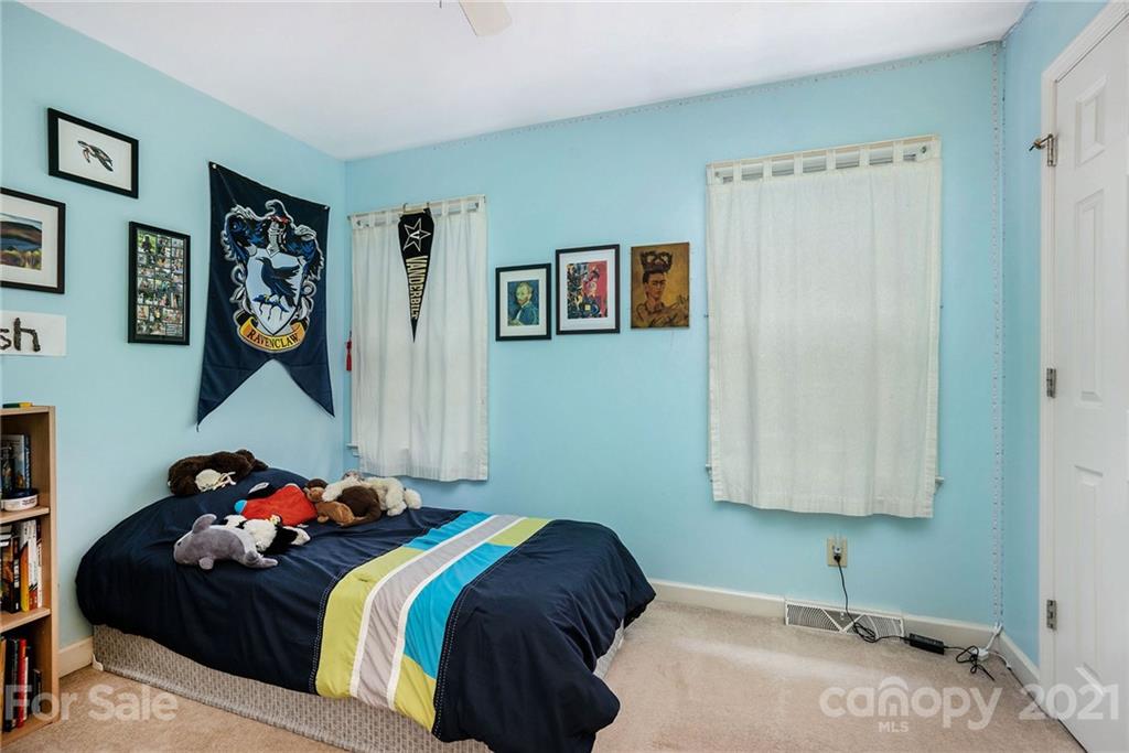 613 Neill Ridge Road Matthews, NC 28105 - Photo 19 of 25 a bedroom with a bed and a painting on the wall