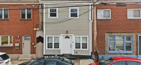 a front view of a house with many windows