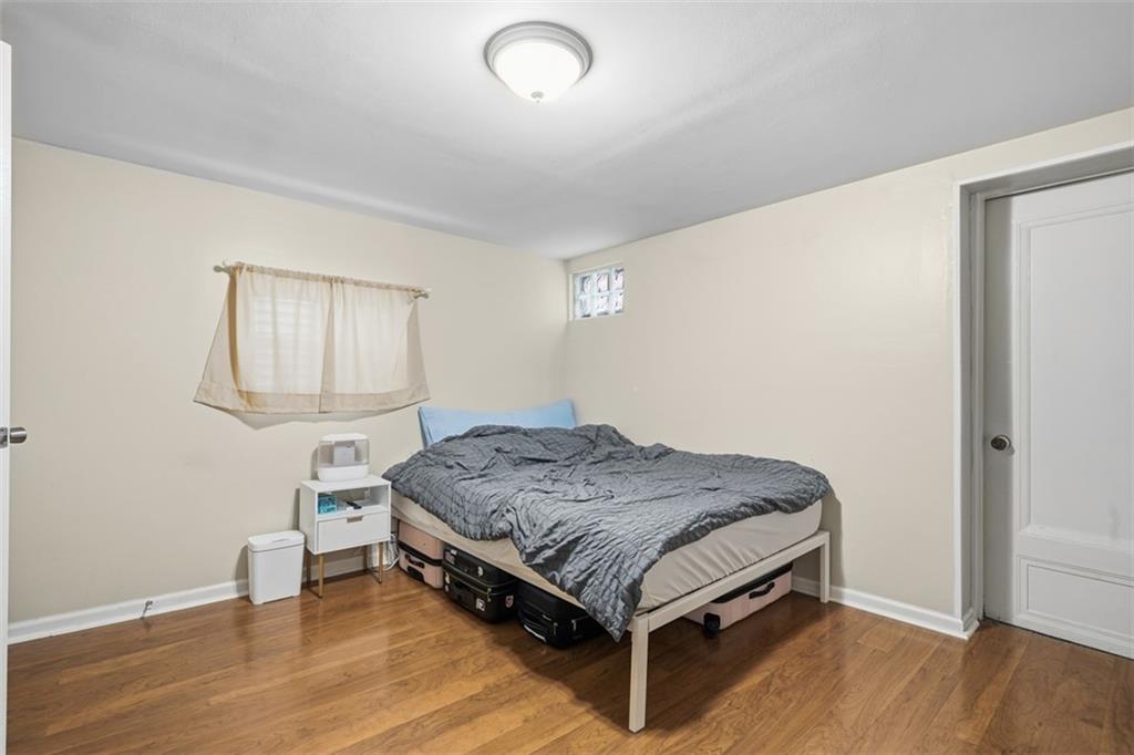 1202 Sarah Street Pittsburgh, PA 15203 - Photo 13 of 37 a spacious bedroom with a bed and a window