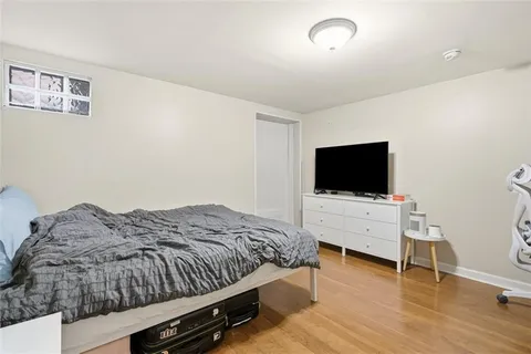 a bedroom with a bed and a flat screen tv