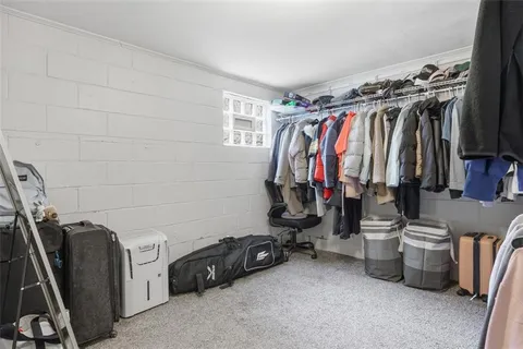 a view of walk in closet with clothes