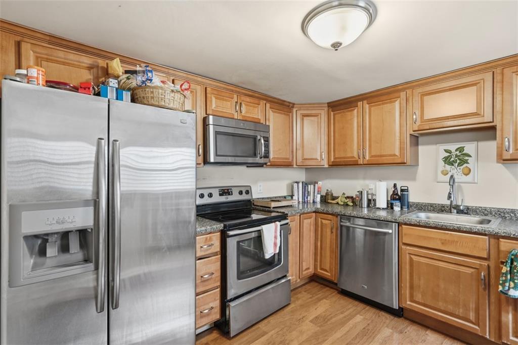 1202 Sarah Street Pittsburgh, PA 15203 - Photo 24 of 37 a kitchen with stainless steel appliances granite countertop a refrigerator a stove a sink and a microwave