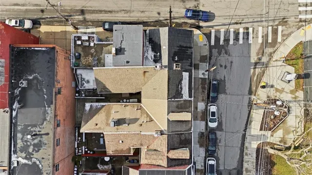 an aerial view of a house with parking space
