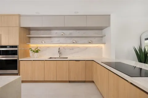 a view of a kitchen with cabinets and wooden floor