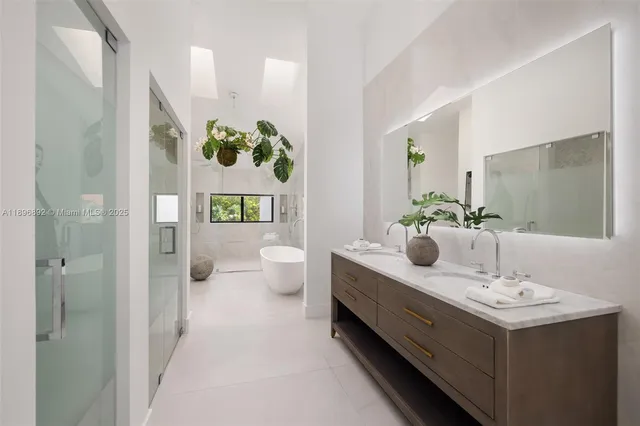 a bathroom with a sink and mirror with toilet