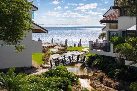 a view of a house with backyard swimming pool and sitting area