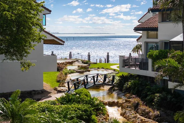 a view of a house with backyard swimming pool and sitting area